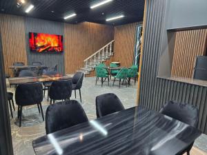 a restaurant with tables and chairs and a staircase at Oscar in Samarkand