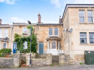 an old stone house with a blue door at Spacious one bed house with parking - Pass the Keys in Bath