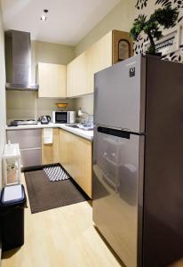 a kitchen with a large stainless steel refrigerator at Spacious 1BR APT near Nightlife and Business Center in Makati in Manila +12 photos