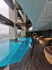 a swimming pool in the middle of a building at Spacious 1BR APT near Nightlife and Business Center in Makati in Manila