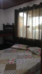 サン・ペドロ・ダ・アルデイアにあるKitnet São Pedro Aldeia 10 min Ilha Boi Lagoa Araruamaの窓付きのベッド