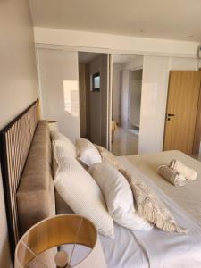 a bedroom with a couch and pillows on a bed at Boa Mindelo Beach in Mindelo