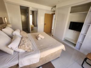 a bedroom with a large bed with white pillows at Boa Mindelo Beach in Mindelo