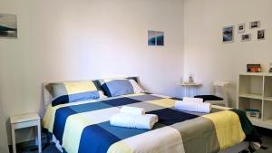 a bedroom with a large bed with two pillows on it at MITO Sea Apartment in Porto San Giorgio