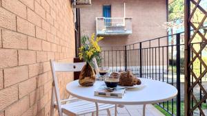 a table on a balcony with two glasses of wine at MITO Sea Apartment in Porto San Giorgio