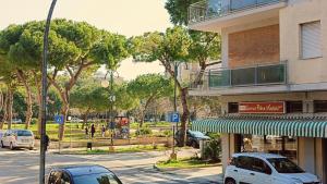 a street with cars parked in front of a building at MITO Sea Apartment in Porto San Giorgio