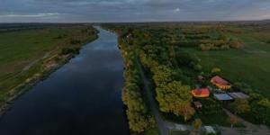 arial view of a river with a house in the middle at Haus 6 am Fluß in Witnica