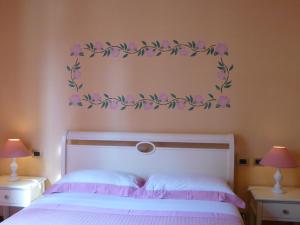 A bed or beds in a room at Locanda Fuoriporta