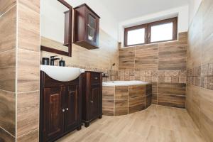 a bathroom with a sink and a tub at wellness Chata u Pinkasů in Písečná +46 photos