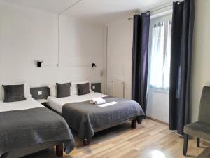 Postel nebo postele na pokoji v ubytování Logis Hôtel La Bastide d'Entraigues