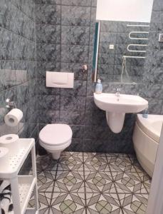 a bathroom with a toilet and a sink at By the beach,by Grand Hotel, Central,Molo in Sopot