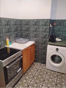 a kitchen with a washing machine and a washer at By the beach,by Grand Hotel, Central,Molo in Sopot