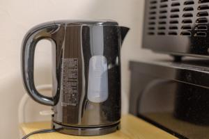 a coffee pot sitting on top of a microwave at LUNA HOUSE 201 New Open near the station 30 sec in Tokyo +15 photos