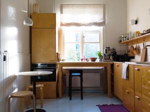a kitchen with a counter with stools and a window at #VILLA Unique Helsinki experience in Helsinki +7 photos