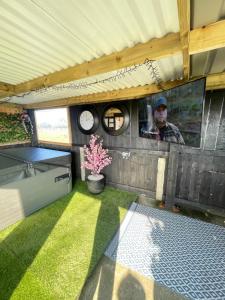 a man taking a picture in the inside of a trailer at The Lodge Mountain View Log Cabin , Attymass Ballina in Boyhollagh