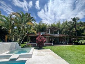 a house with a swimming pool in front of a yard at Chalet Casa Campestre Villa del Sol in La Tebaida