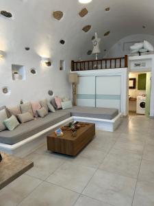 a living room with a couch and a coffee table at Tholari Allegro in Astypalaia Town