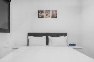 a white bed with white sheets and pillows at Luxury Suite Apartment #66 By Hashdera Eilat in Eilat +12 photos