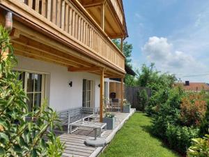 a porch of a house with a bench on it at Alz-Apartment in Seeon-Seebruck +17 photos