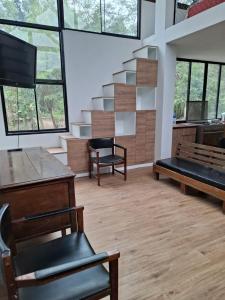 a room with benches and a staircase with windows at Cabañas o habitación en Fundo Huabayor in Lima