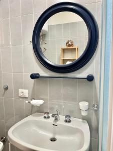 a bathroom with a sink and a mirror at EC apartment in Scalea