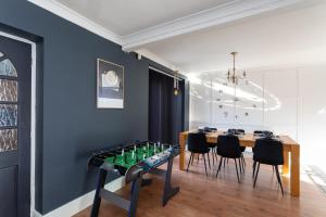 a dining room with a table with bottles on it at Newly Refurbed Home With Football Table Near M5 Junction 2 in Oldbury