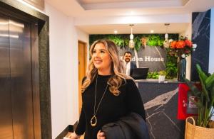 a woman standing in a hotel lobby at Royal Apartments Bournemouth in Bournemouth