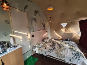 a small bedroom with a bed in a room at Hilltop Paradise in Kodaikānāl +62 photos