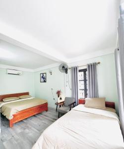 En eller flere senge i et værelse på Luti Homestay and Restaurant