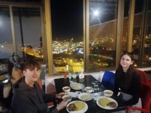 a man and a woman sitting at a table with food at Petra Planet in Wadi Musa +35 photos