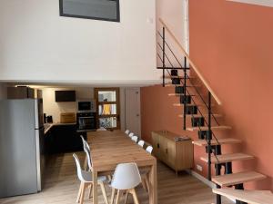 a dining room and kitchen with a table and chairs at L'îlo'T in Ker Pierre Borny