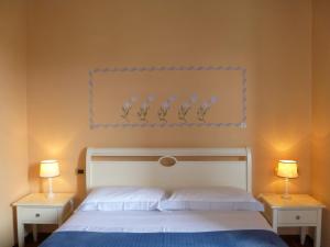 A bed or beds in a room at Locanda Fuoriporta