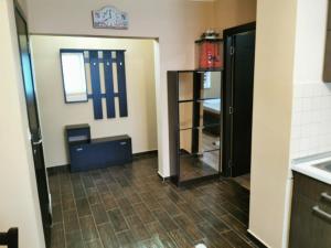 a kitchen with a refrigerator and a counter top at Tranzit Apartman 2 in Odorheiu Secuiesc