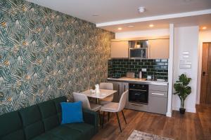 a living room with a green couch and a table at Royal Apartments Bournemouth in Bournemouth