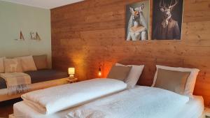 a bedroom with a bed and a couch at Stay Novy in Bach