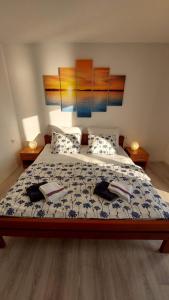 a bedroom with a bed with two books on it at Bravarica blue in Potocnica +2 photos