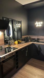 a kitchen with a sink and a counter top at Romantic apartment near Paris in Maintenon +15 photos