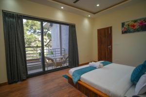 a bedroom with a bed and a large window at Kasauli Vista in Kasauli +31 photos