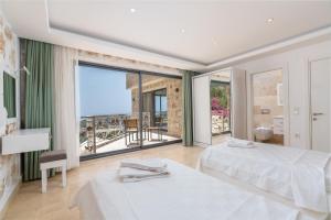 a bedroom with two beds and a view of the ocean at Serin Villas in İslâmlar +291 photos