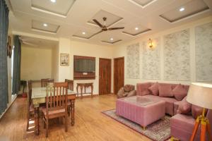 a living room with a couch and a table at Kasauli Vista in Kasauli