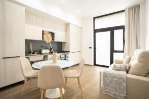 バレンシアにあるValencia Central Flats-Elegante, junto al Roig Arenaのテーブルと椅子のあるキッチンとリビングルーム