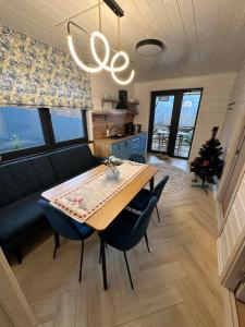 a dining room with a table and a couch at Power Place in Mizhhirya