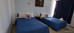 Cama ou camas em um quarto em Hotel Coral