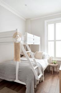 a white bedroom with a white bunk bed at Driftwood House in Bournemouth