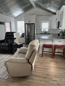 a living room with a couch and a kitchen at Cozy Cabin in Brazoria