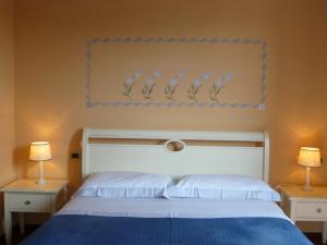 A bed or beds in a room at Locanda Fuoriporta