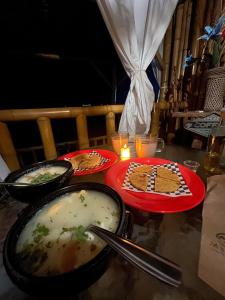 a table with plates of food on top at Mambe refugio in Piedecuesta