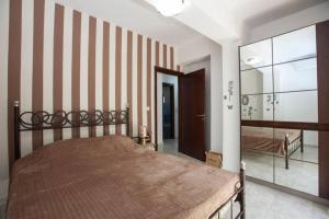 a bedroom with a bed and a large mirror at Natural Quiet Accommodation 2 - Faliraki in Kalithies