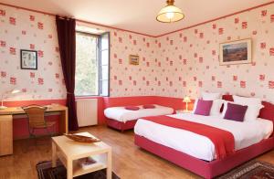 a hotel room with two beds and a desk at Gites La Sauvageonne in Saint-Palais +52 photos