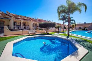 a swimming pool in front of a house at CH Limonero Doña Pepa in Rojales
